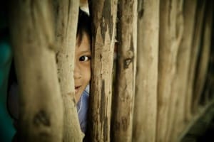 Child behind Bamboo Fence